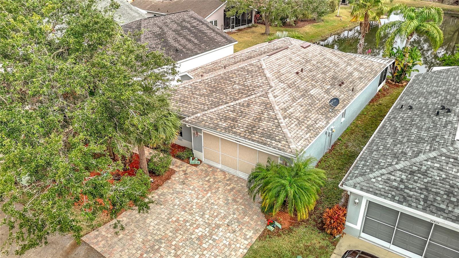 Aerial view of the home and paver driveway