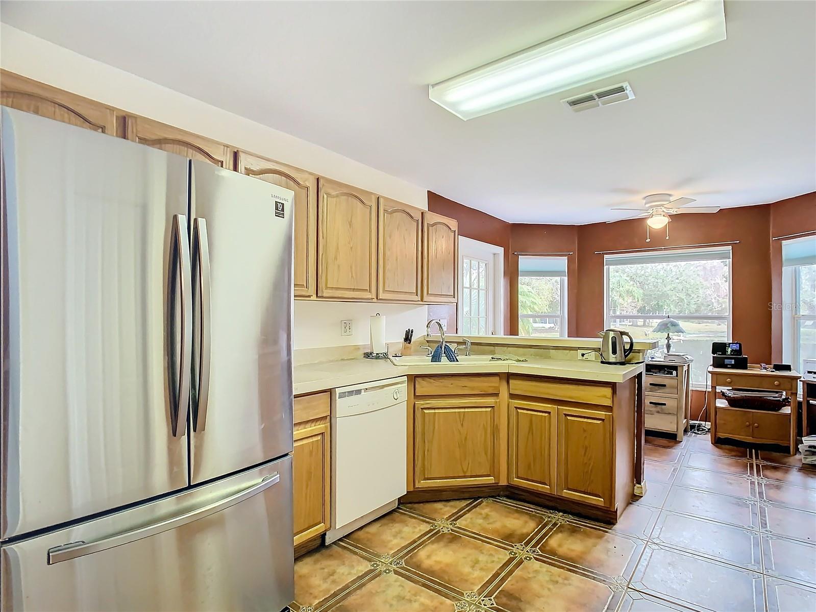 Kitchen with stainless refrigerator