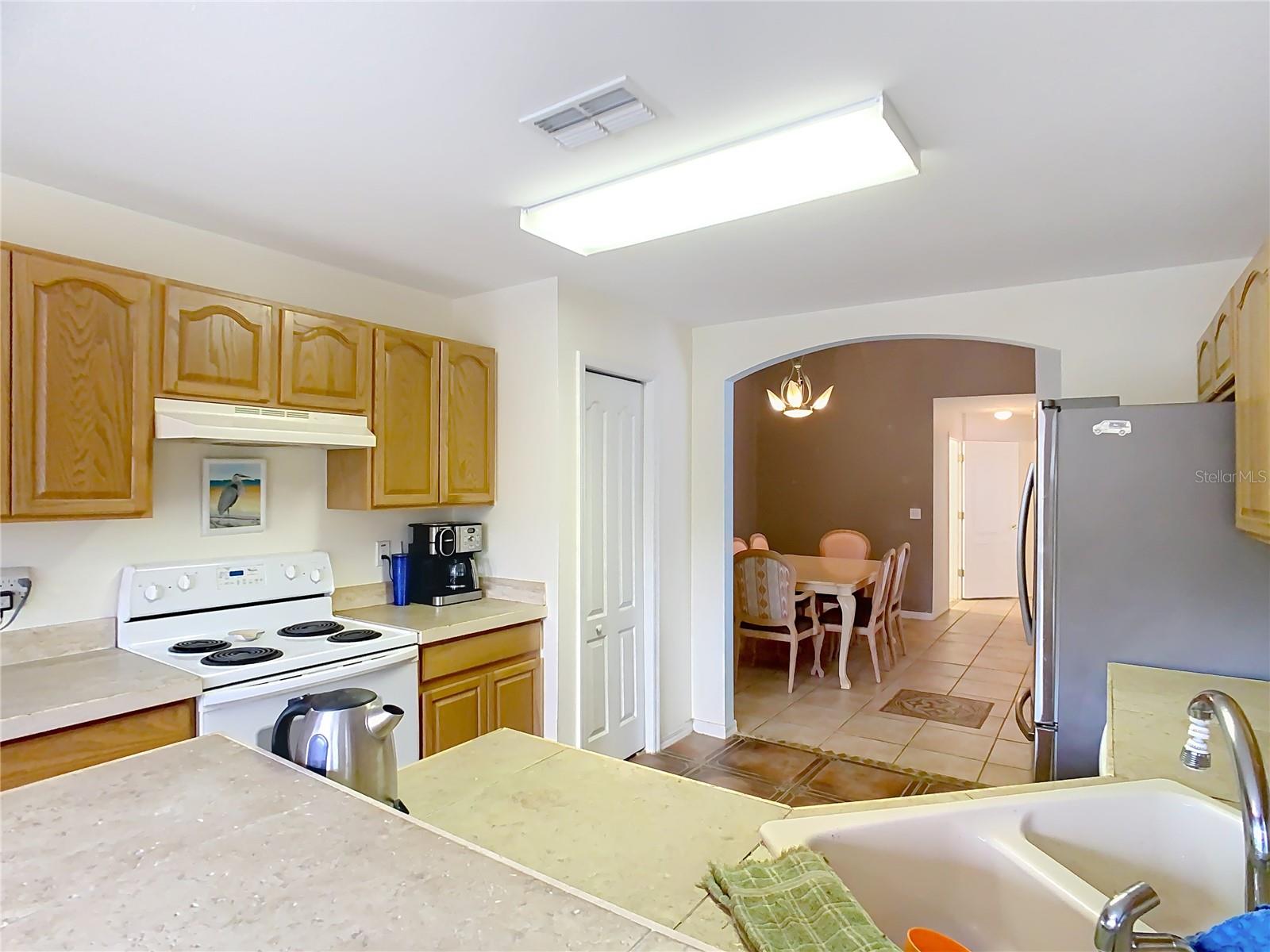 Kitchen overlooking the dining room through the archway