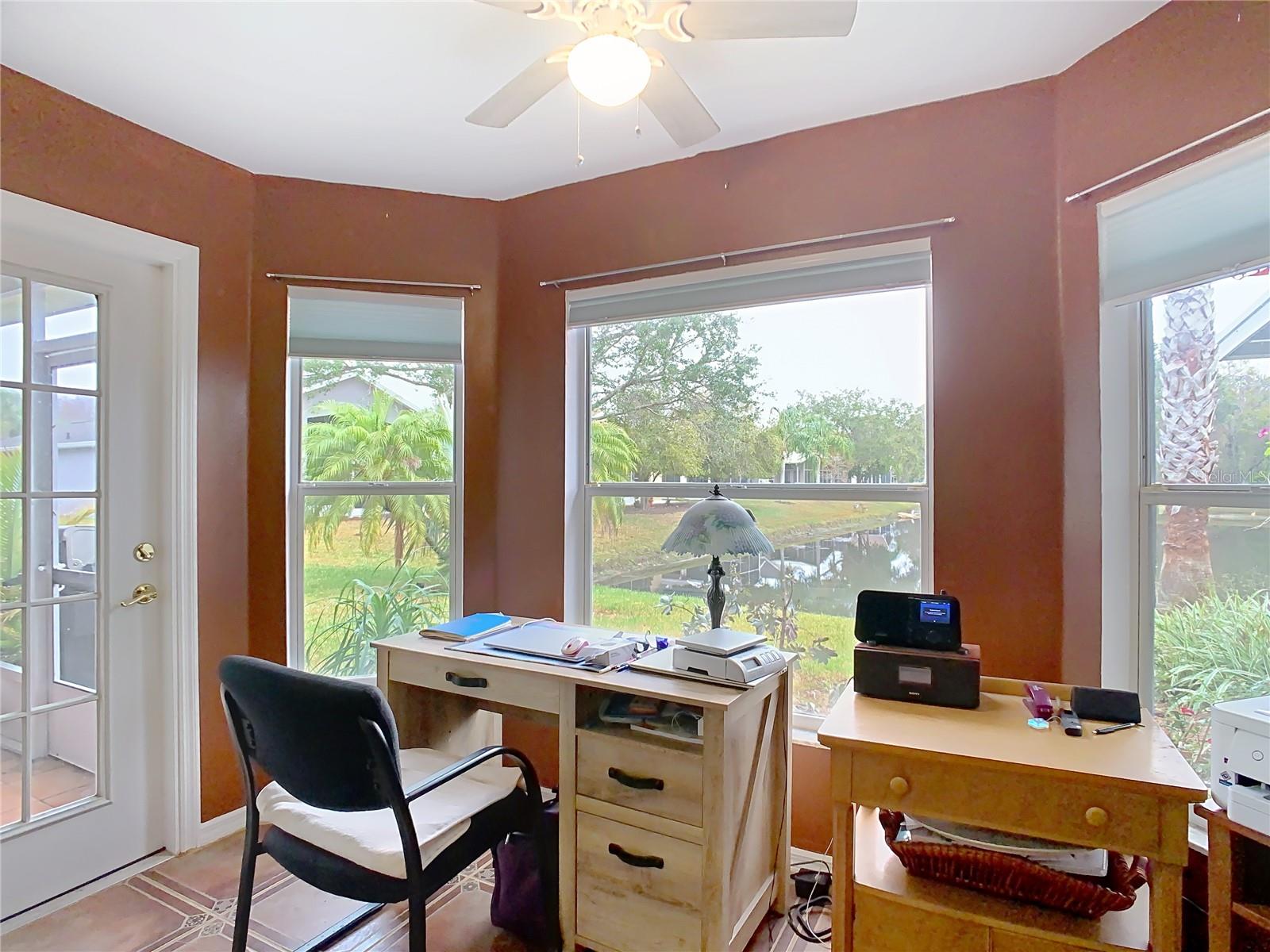 Dinette with ceiling fan looking out over the backyard pond