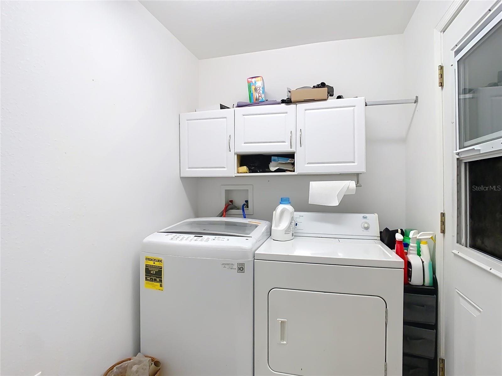 Indoor laundry room leading to the garage