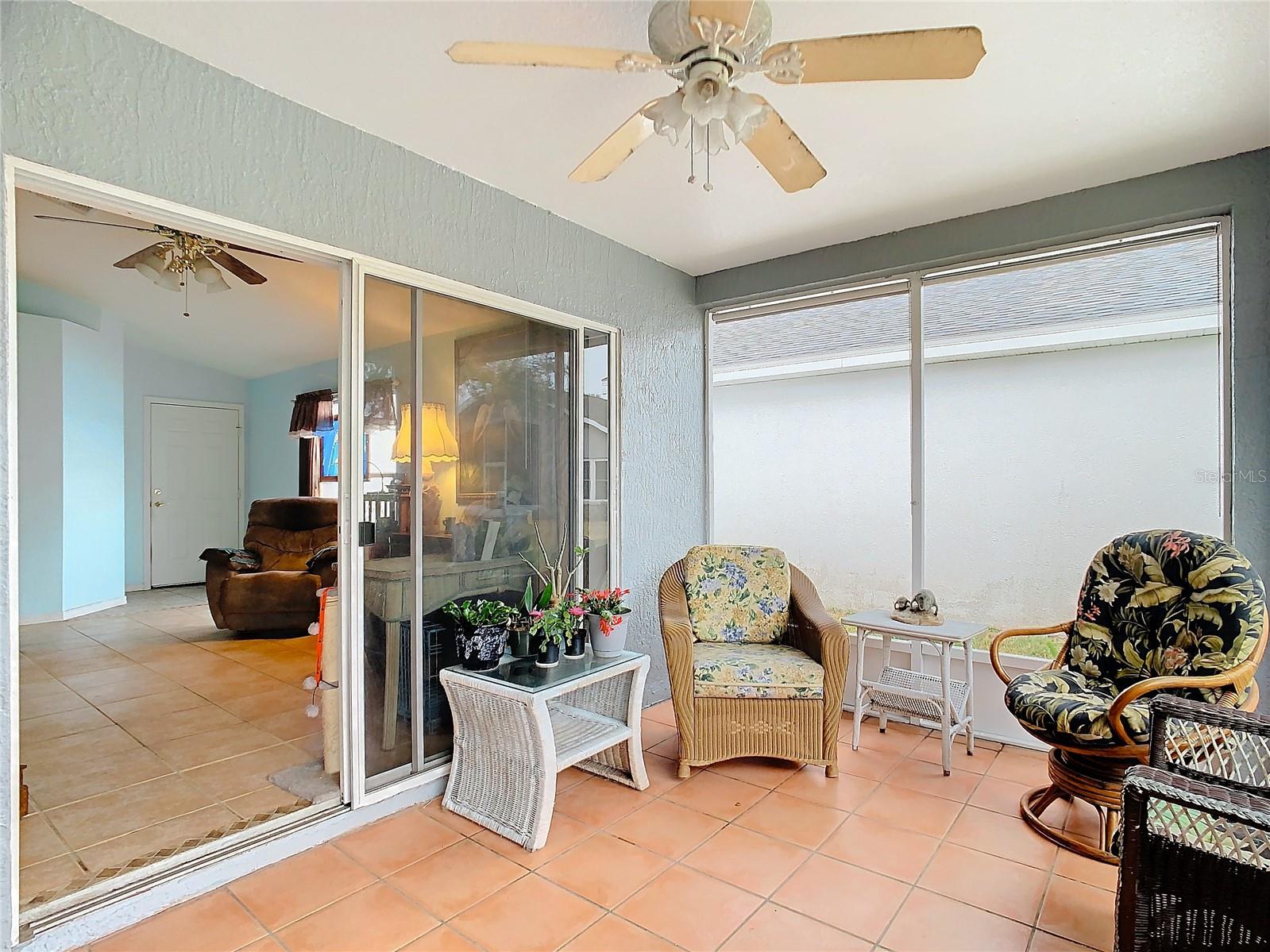 Living room screened lanai leading into the living room through the sliding doors