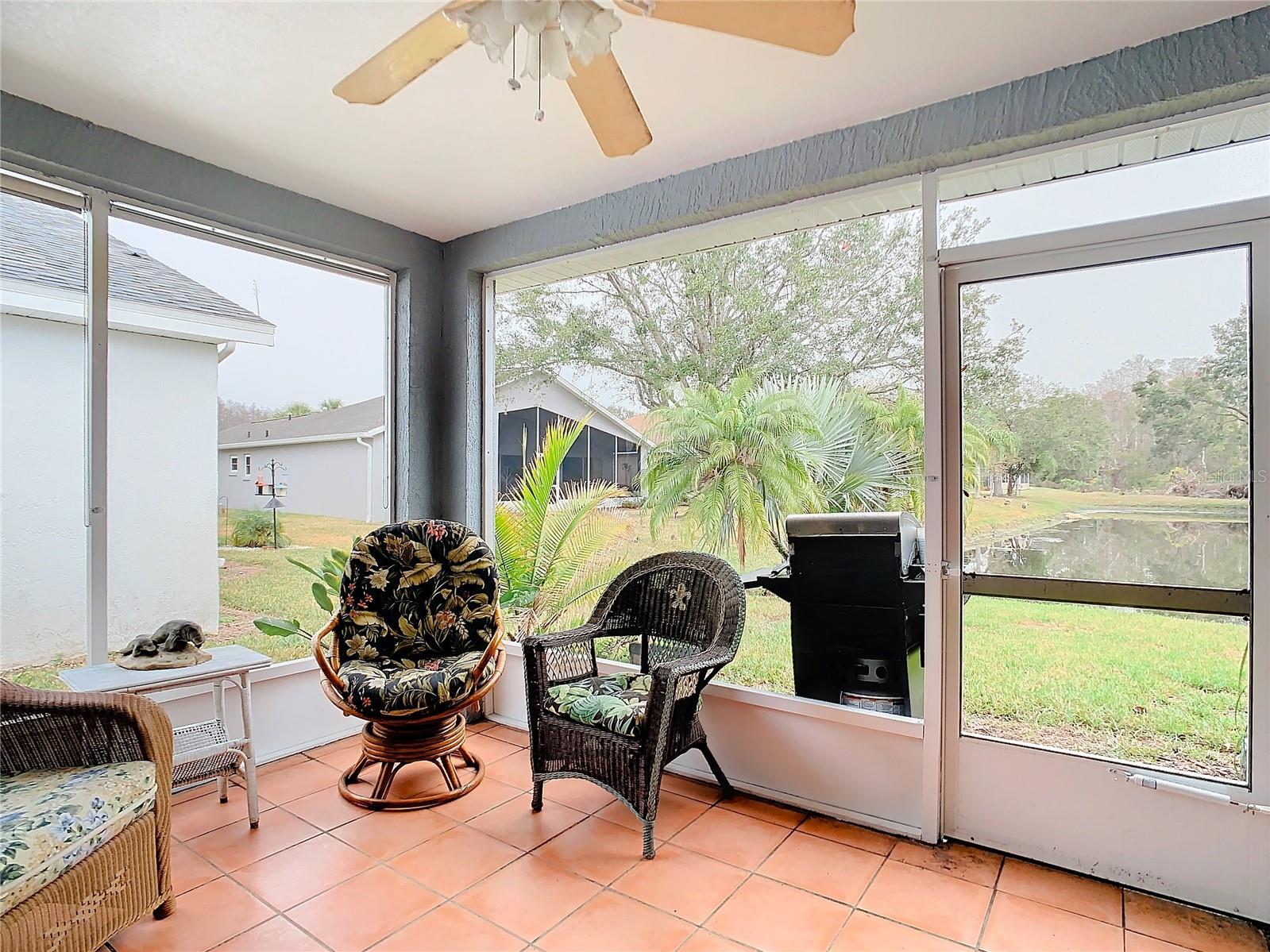 Living room lanai looking over the backyard pond