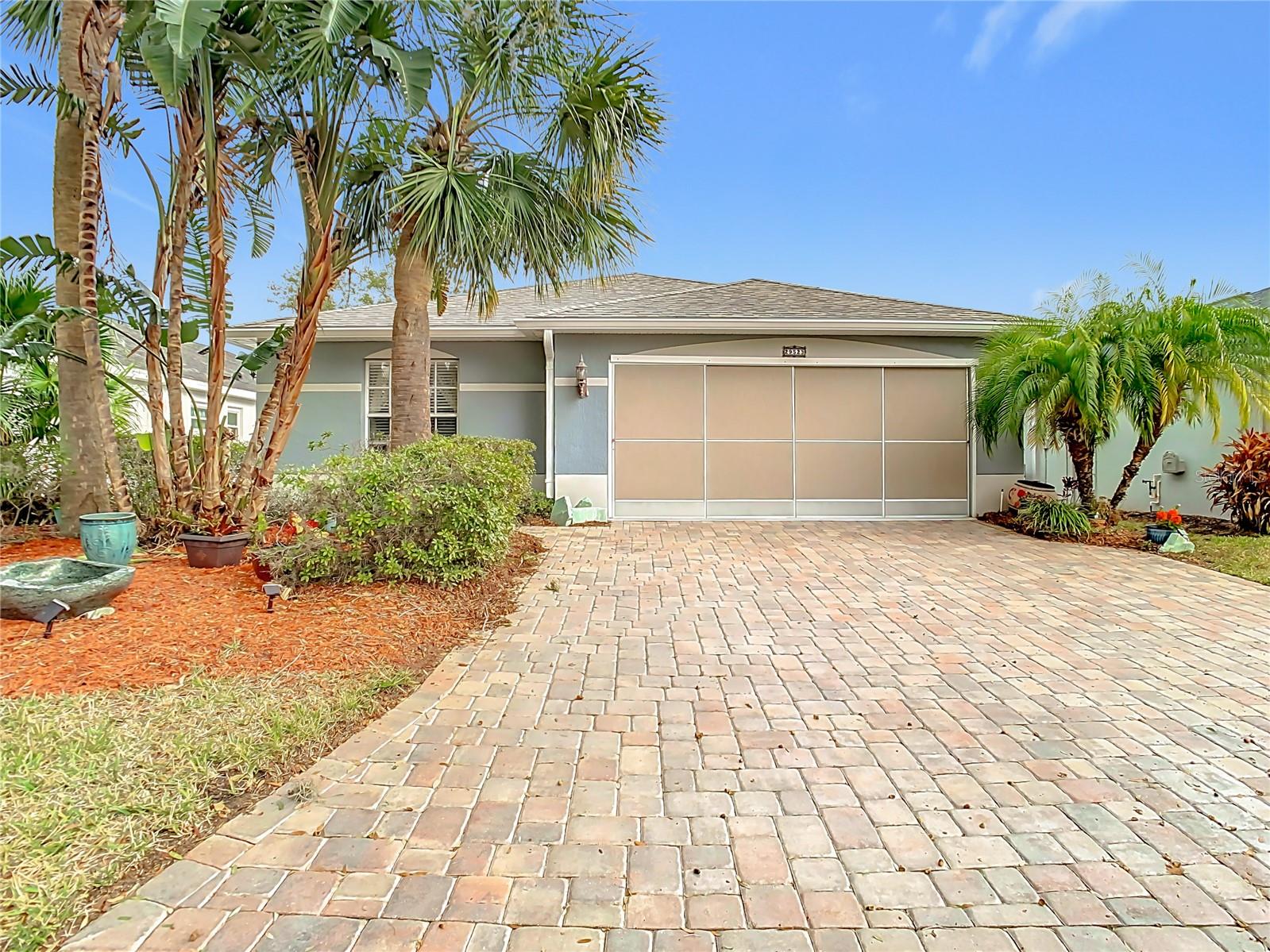 Front view of the home with beautiful paver driveway