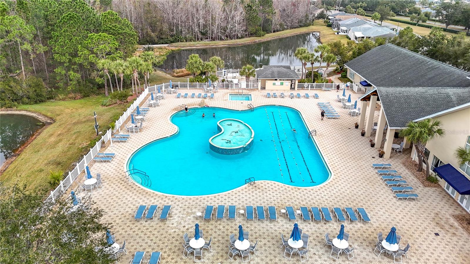 Aerial view of the main exquisite pool overlooking ponds and woods