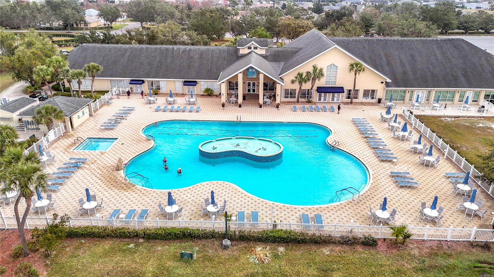 Aerial view of the main exquisite pool outside of the vast clubhouse