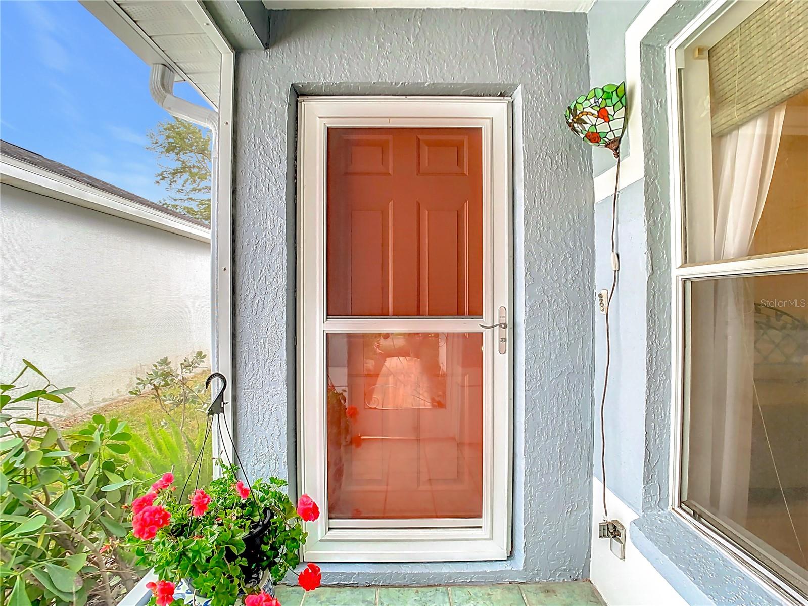 Front door with glass door inside the screened entryway