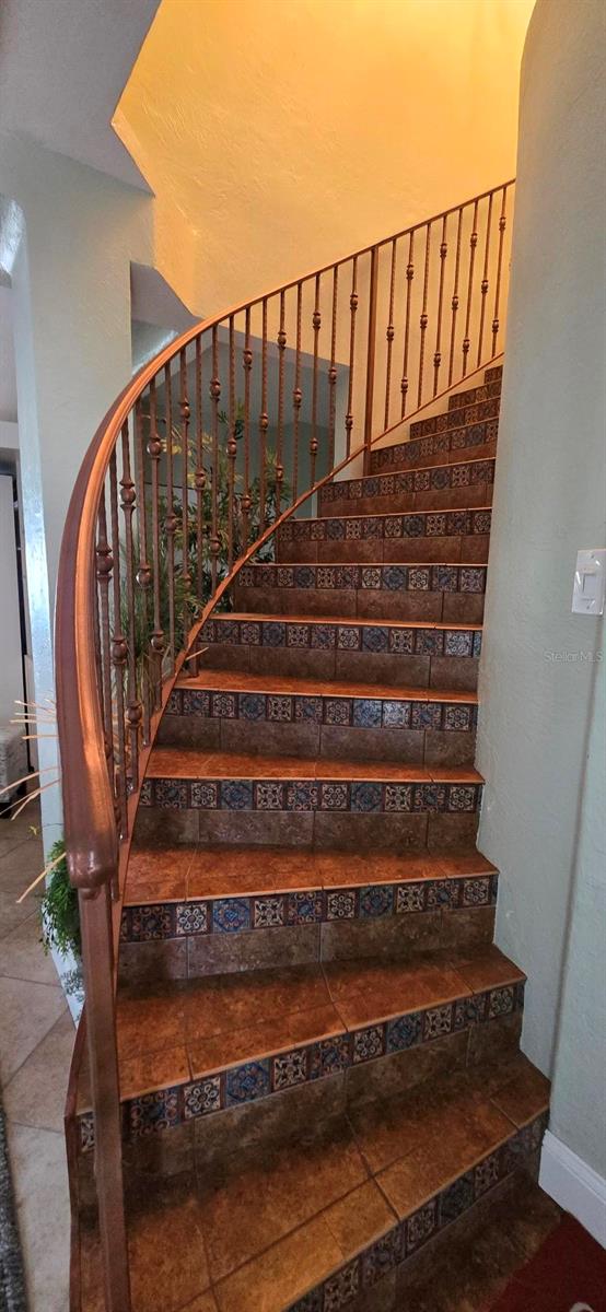 Stairs from primary bedroom to foyer. (Triplex unit 1, 2-story, 1996 sq ft, 3/3). Pic taken before Hurricane Helene.