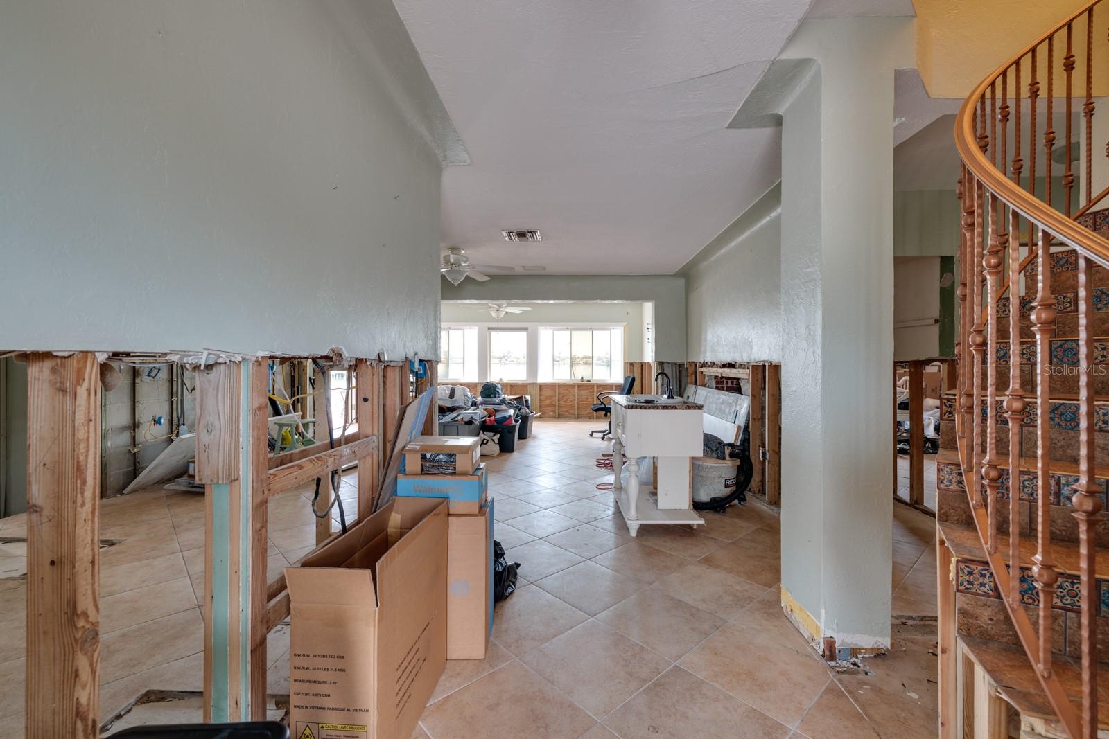 Foyer (1st floor). Kitchen on left. Stairs to primary bedroom. (Triplex unit 1, 2-story, 1996 sq ft, 3/3).