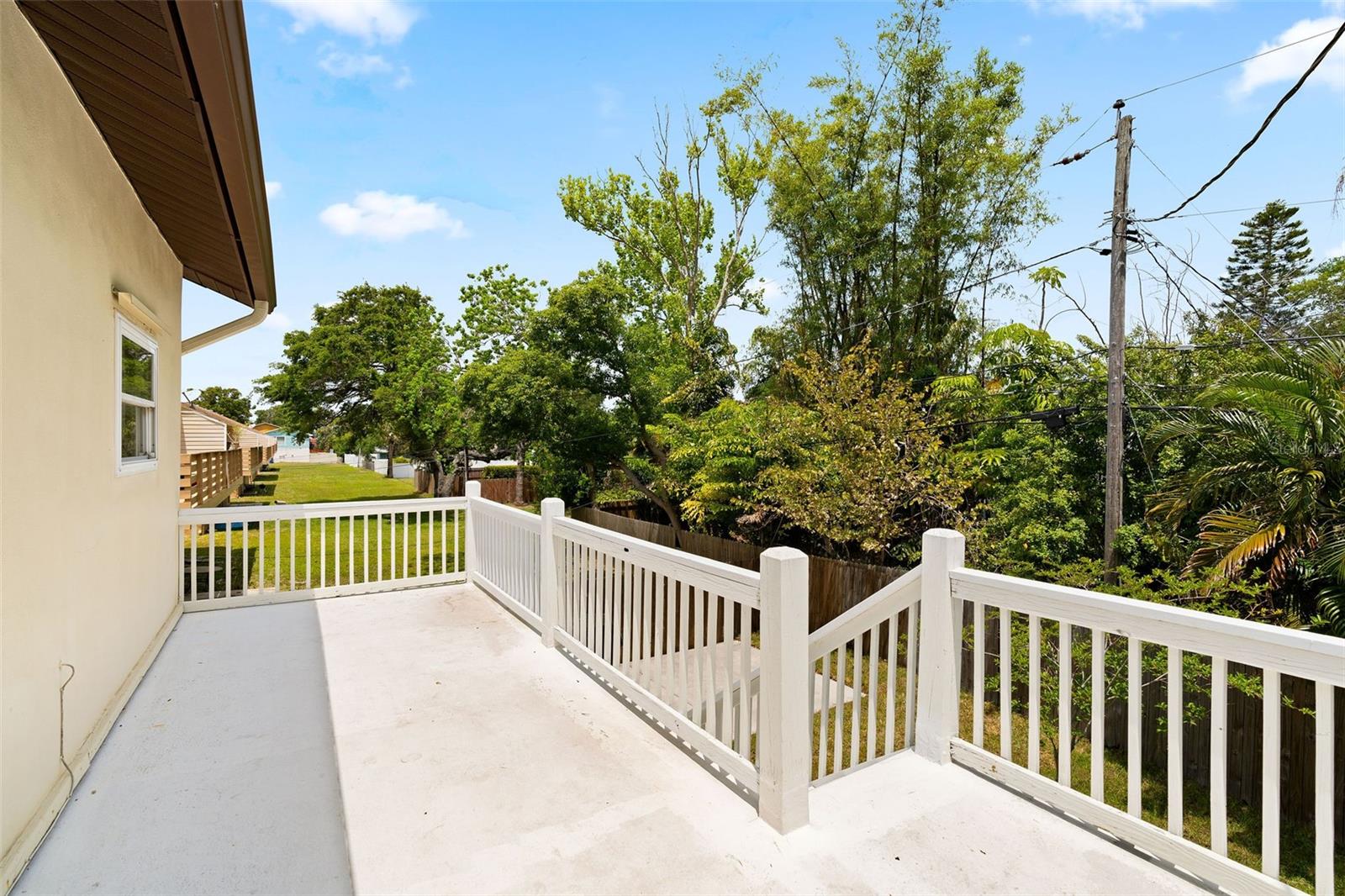 balcony from primary bedroom walks down to yard.