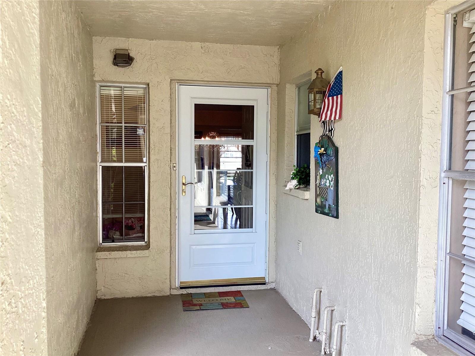 Front entrance with a storm door.