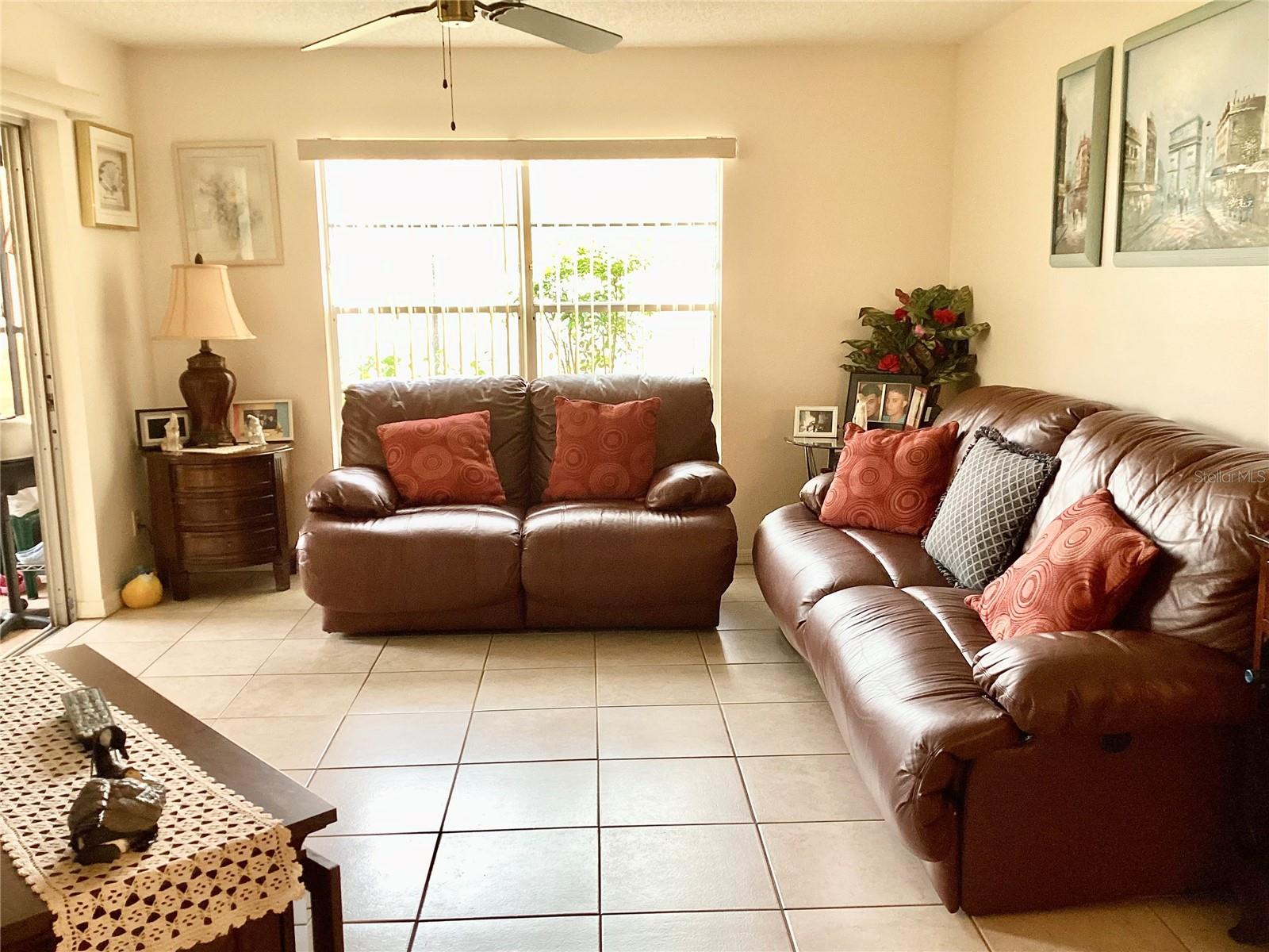 Living area with sliders onto Florida room.