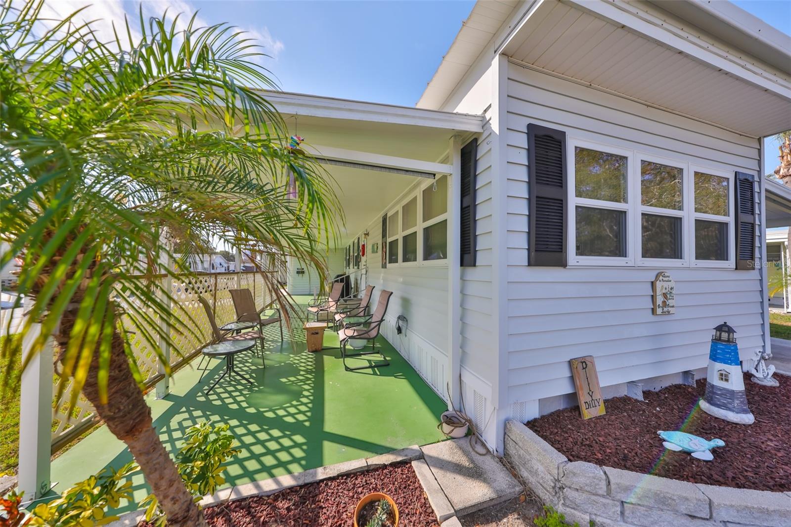 Secluded front porch with roll-down privacy screens.