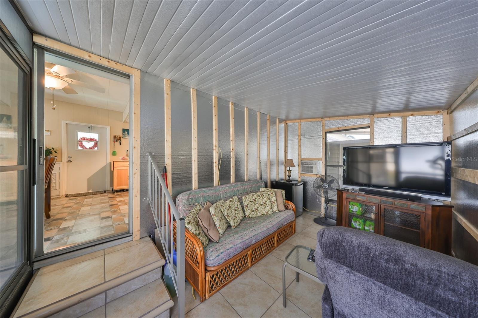 from kitchen to Florida Room.  Imagine it drywalled or converted back to screened-in porch.