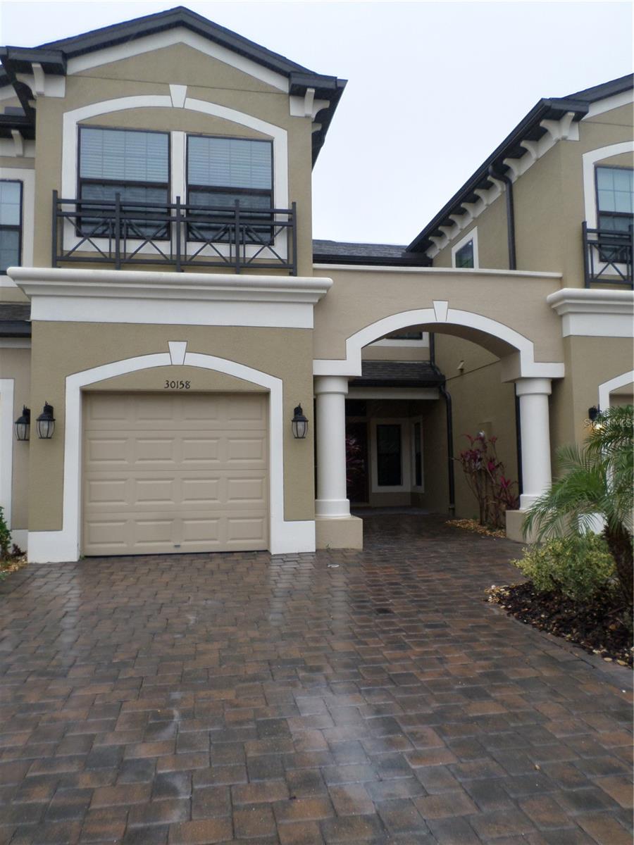 Front of townhome has a front porch