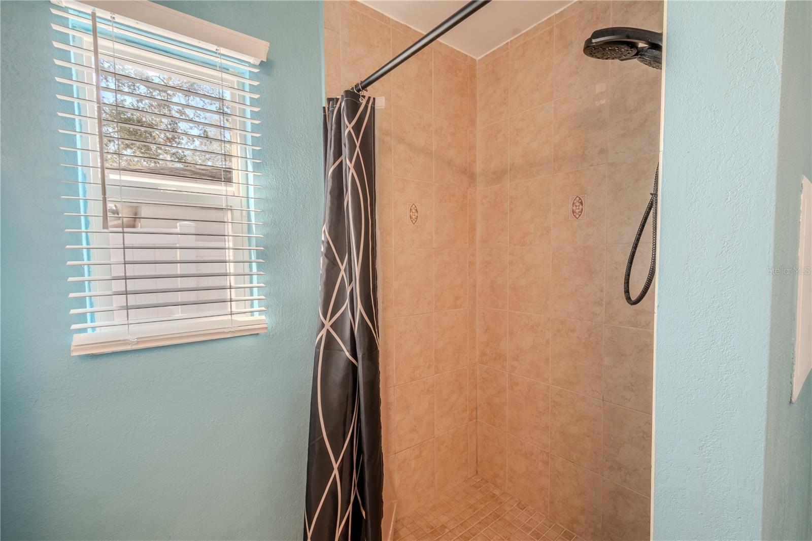 The primary ensuite bath features a tiled step-in shower.