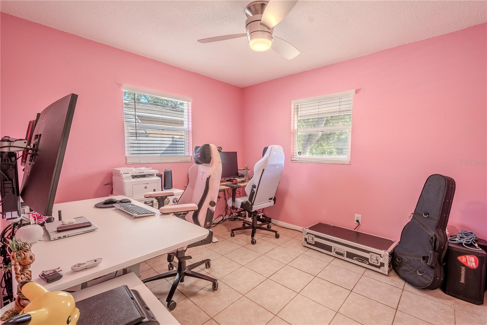 Bedroom 3 (currently used as a home office) has a modern ceiling fan, tile floor and a built-in closet.