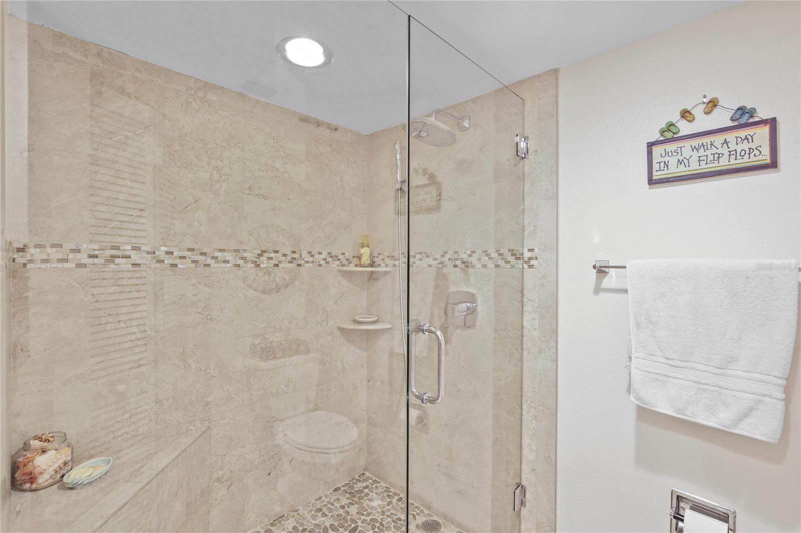 A large, step-in shower in the Primary Suite