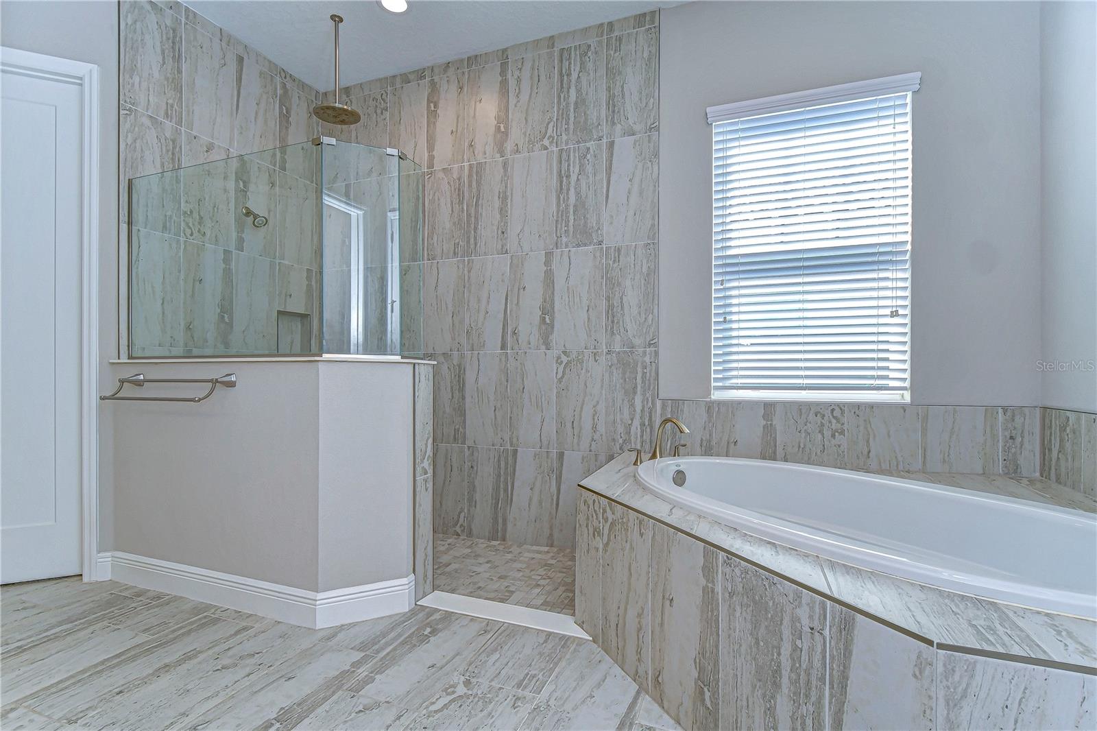 Large shower with rainfall shower-head  and large stand alone soaking tub!