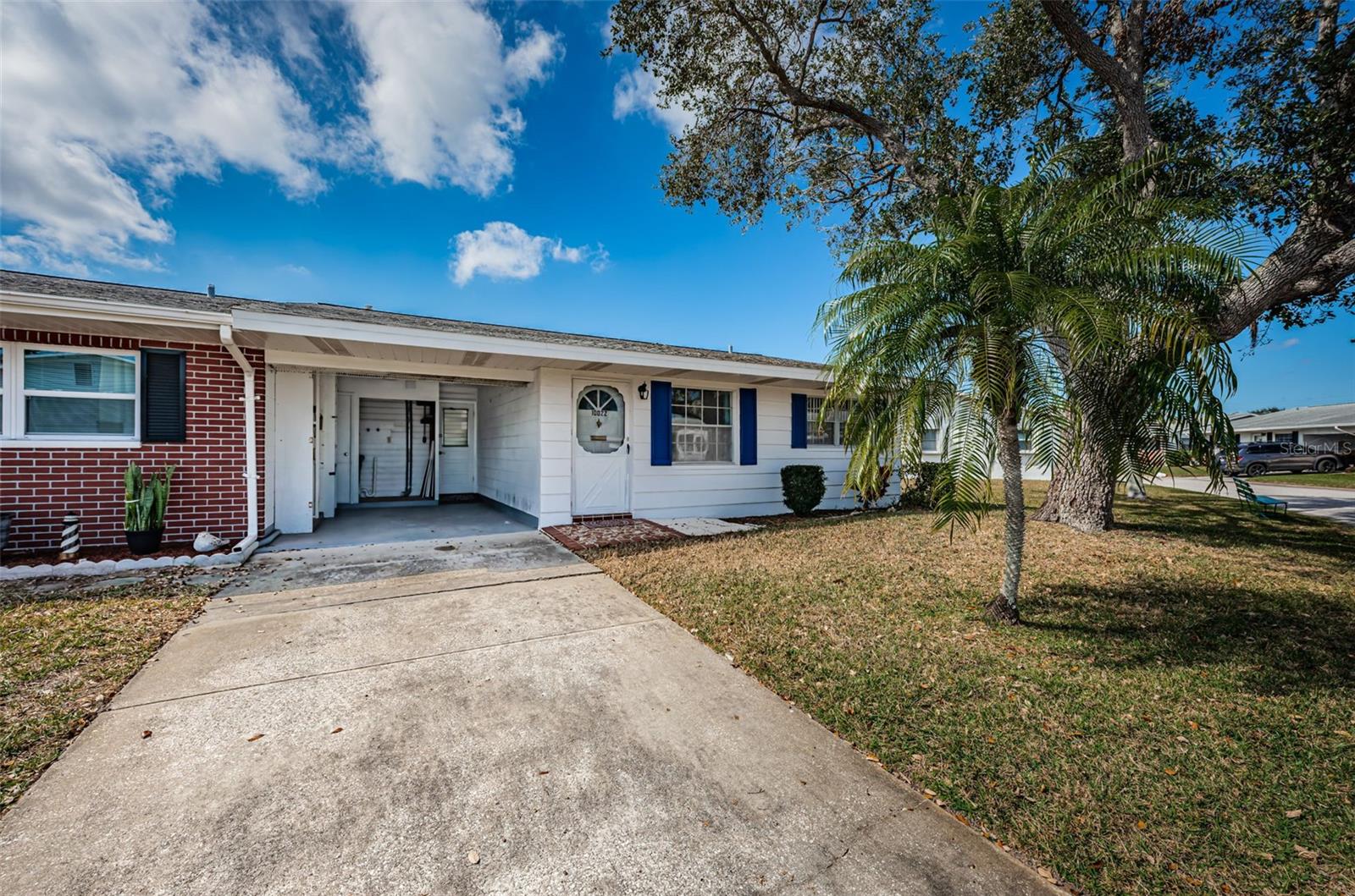 Front view with carport and driveway