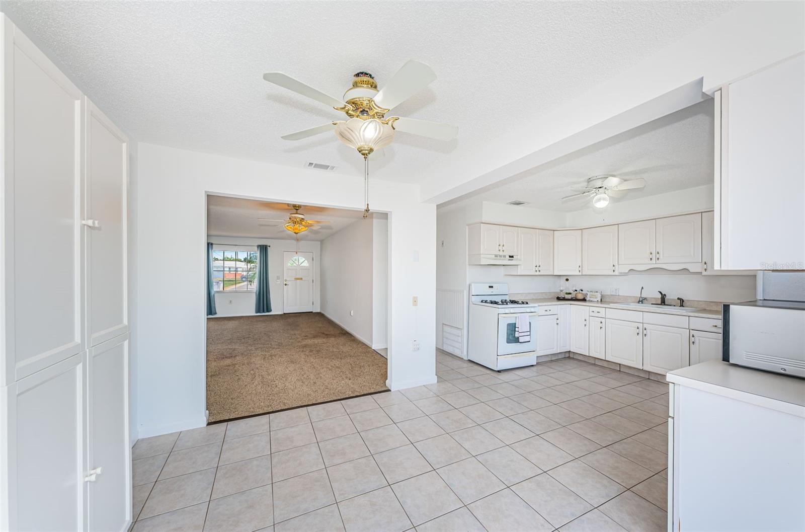 View from dinette into kitchen and living/dining area