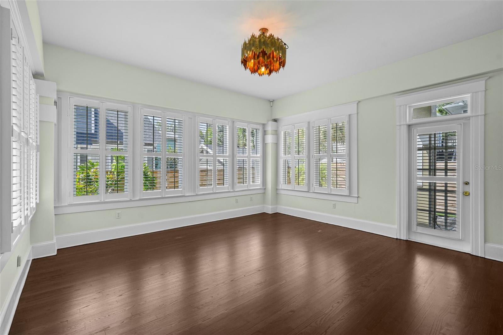 Downstairs Primary Bedroom: High ceilings, abundant light and newly refinished hardwood flooring are just a few of the noteworthy features.