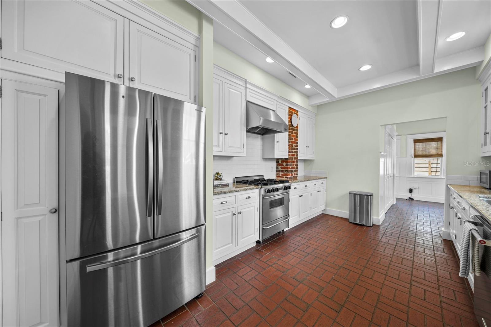 Updated, light filled kitchen with updated appliances (dishwasher & refrigerator 2023), FIVESTAR gas range and hood. Notice the beautiful beams on the ceiling.