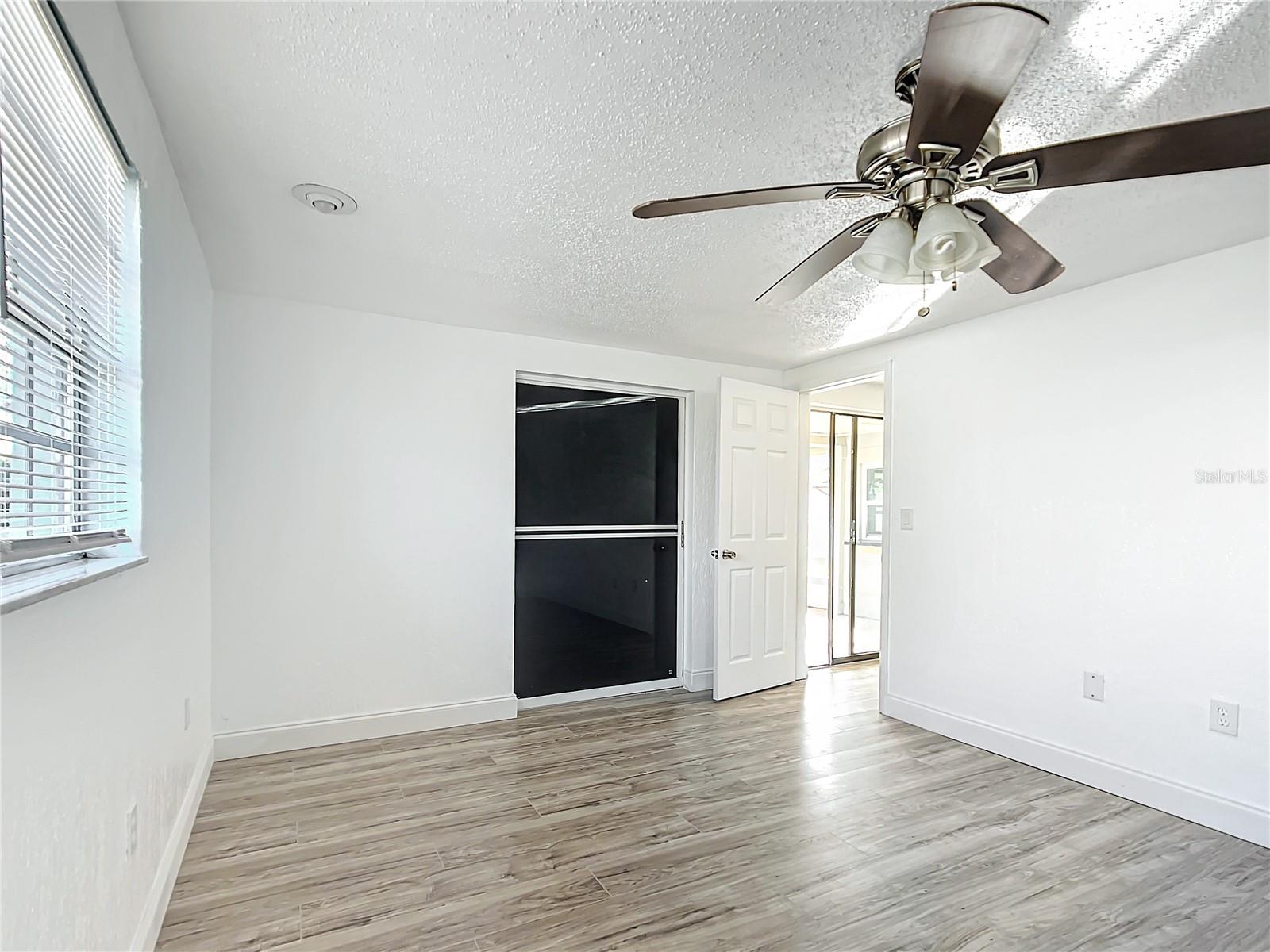 primary bedroom with a slider to Lanai