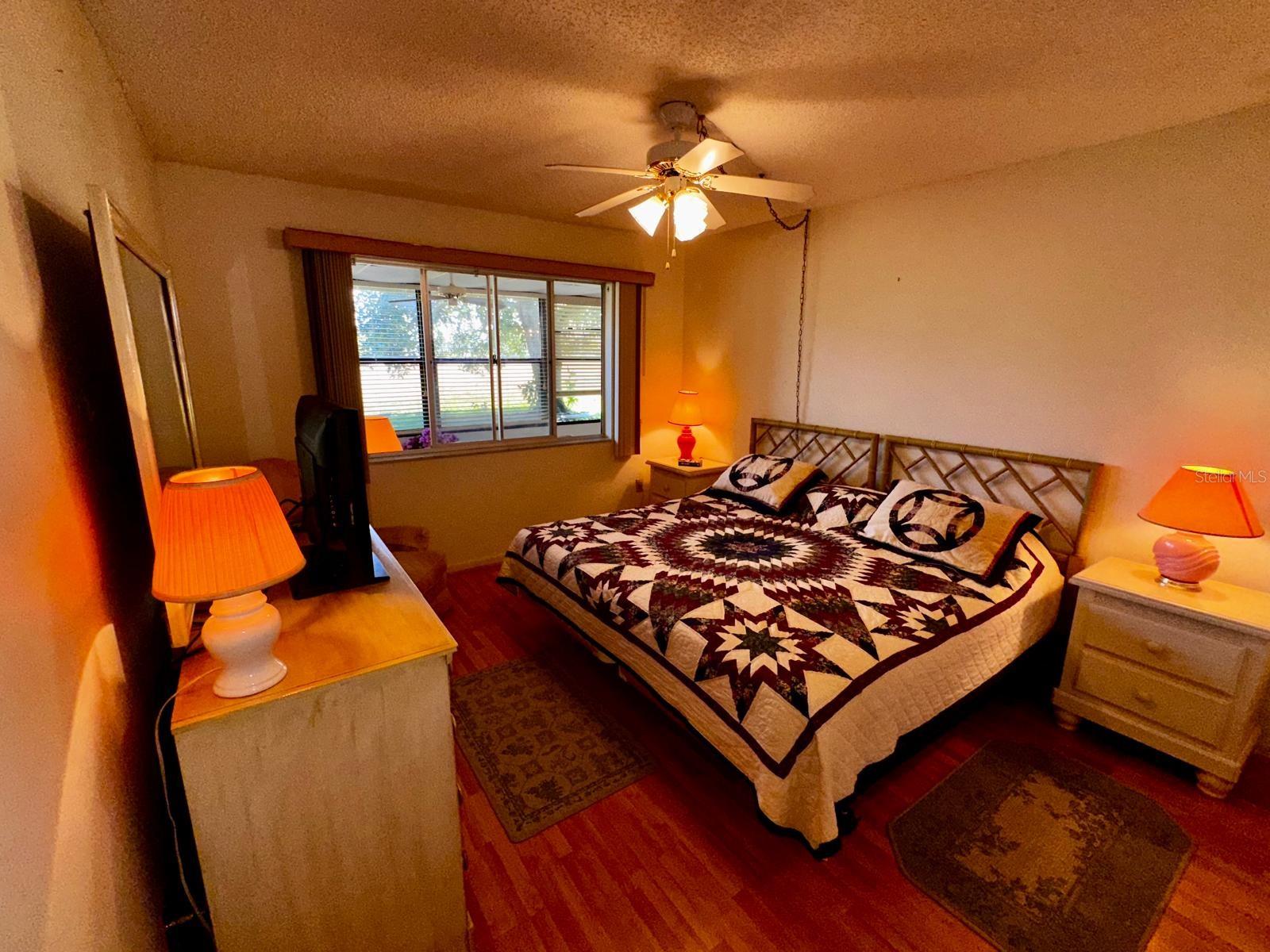 Second Bedroom with window open to porch and large window to see nature park views