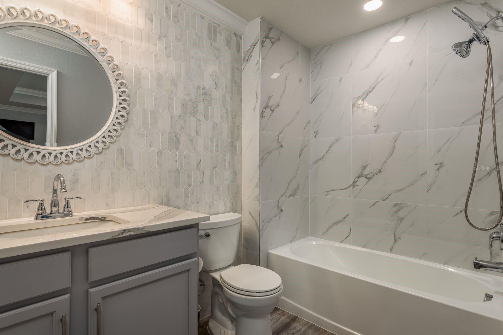 Third bathroom also fully upgraded with new tile and backsplash wall.