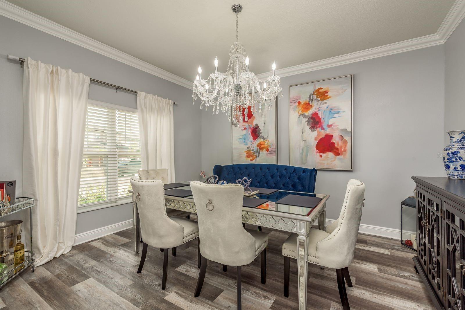 Formal dining with Z Gallery Chandelier. Crown Molding composing the space.