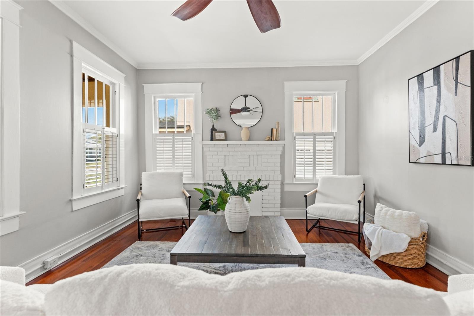 Living Room with original hardwood floors and brickwork from decorative fireplace