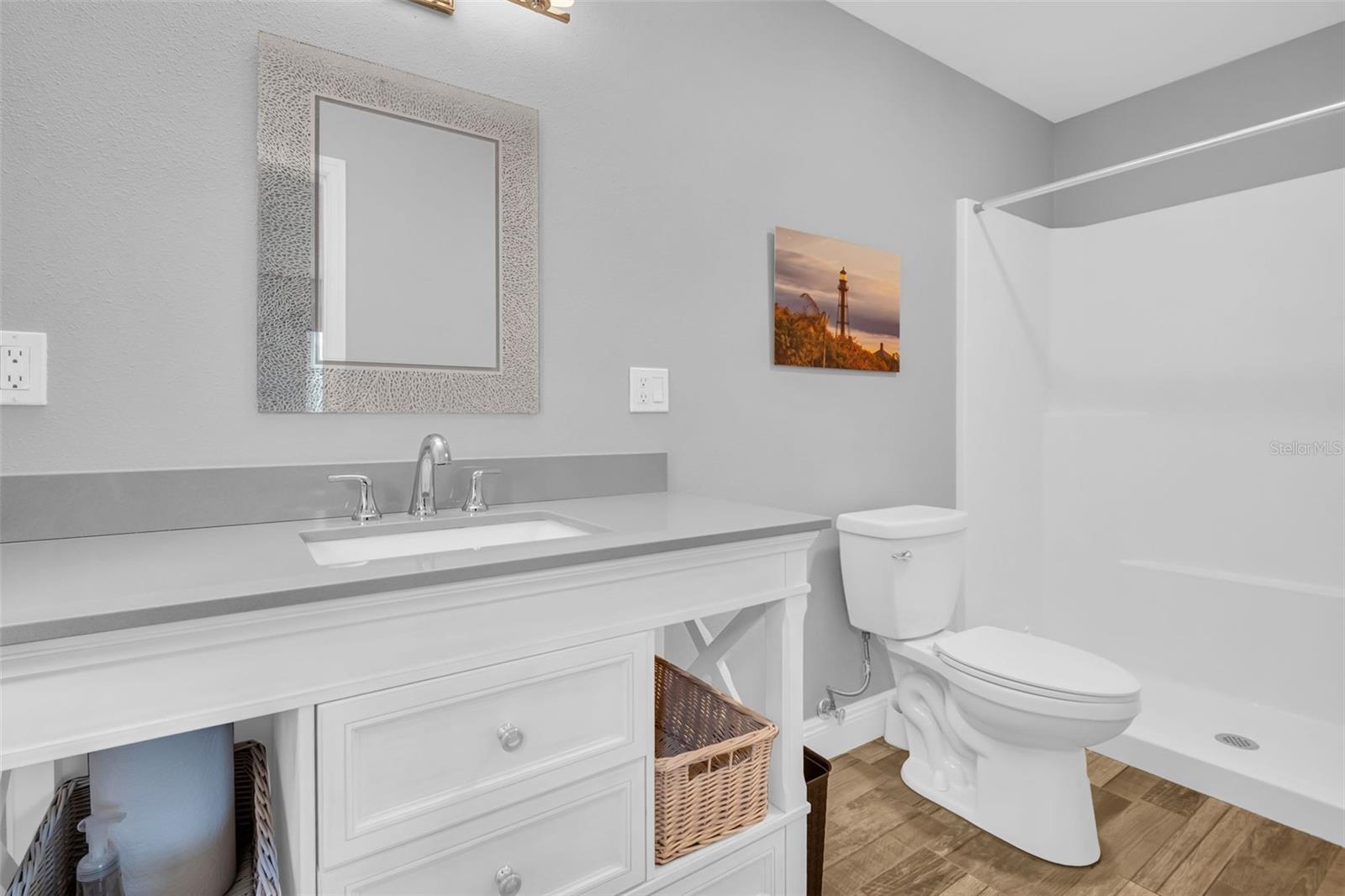 Renovated en-suite with new vanity, lighting, and walk-in shower~