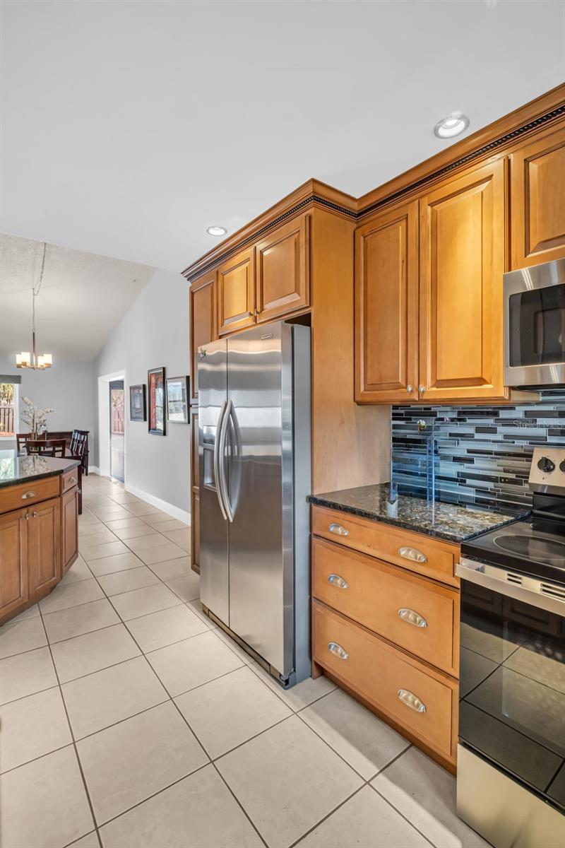 Solid wood cabinets, granite countertops, sleek backsplash, and newer stainless appliances~