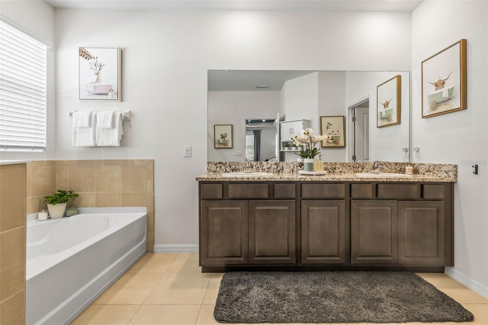 Ensuite bath to the primary bedroom has dual vanities, tub and walk in shower!