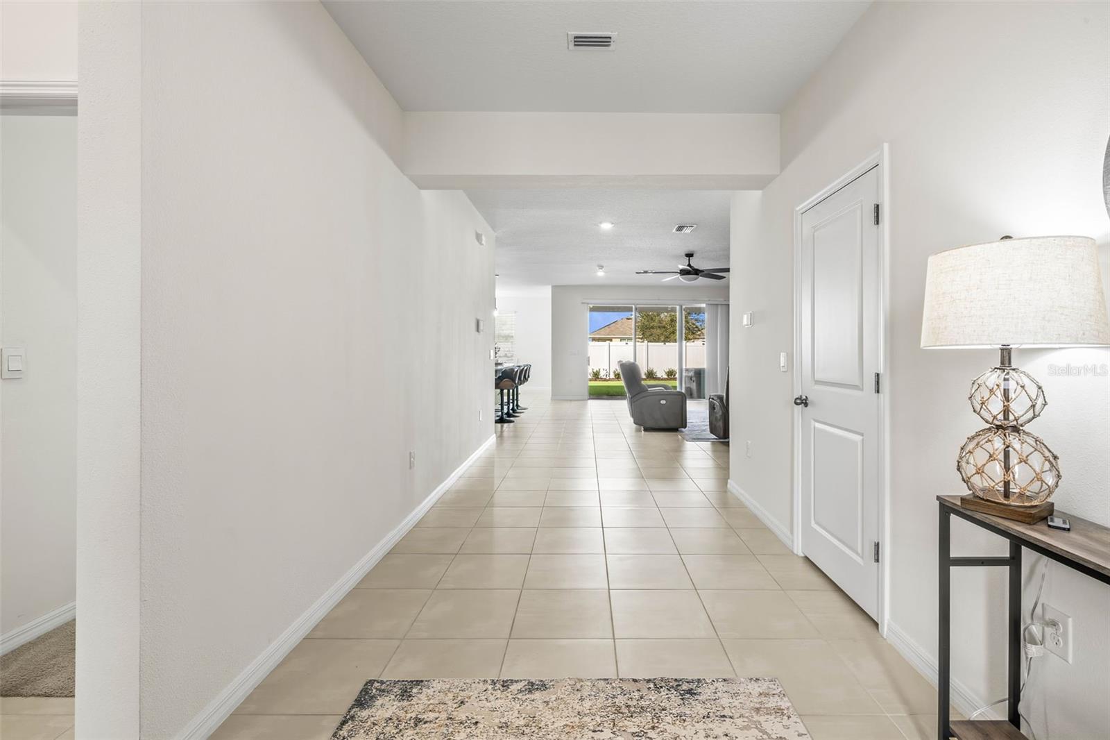 The entryway pours in natural light with high ceilings & tile flooring throughout.