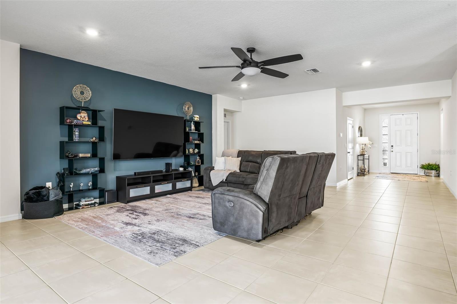 Accented wall and overhead fan make this area comfortable all year round.