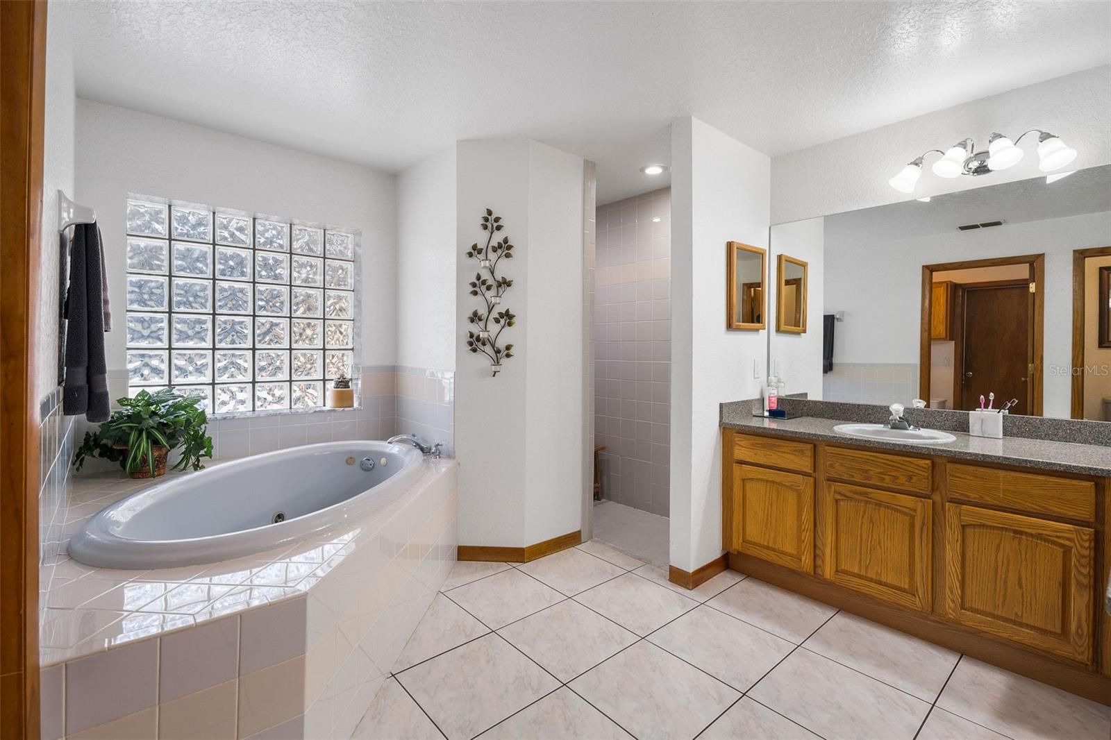 En Suite bath with water closet, dual sinks, jetted tub, & separate shower