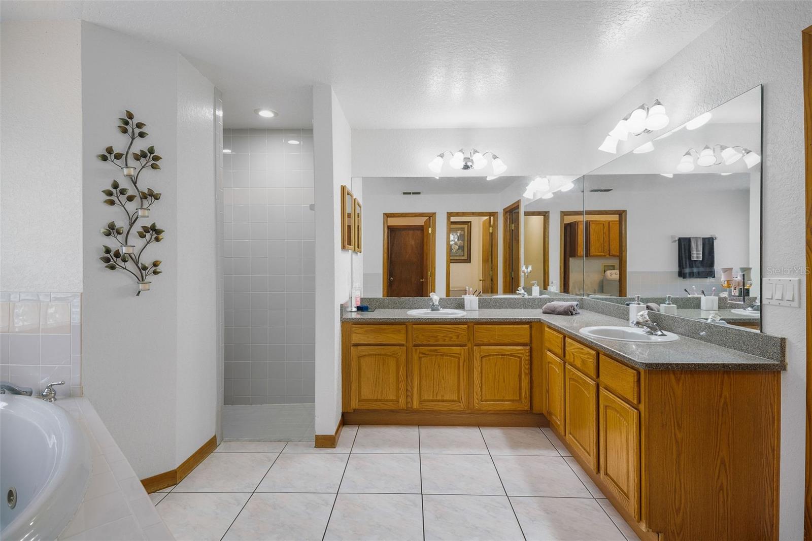 En Suite bath with water closet, dual sinks, jetted tub, & separate shower