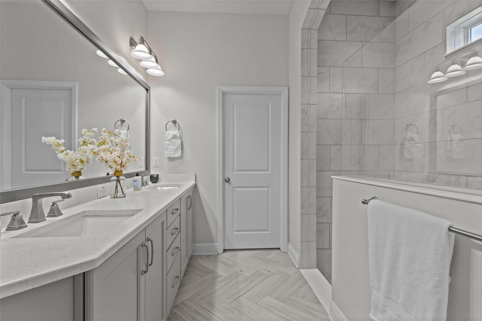 Primary bathroom - double sinks, quartz counters, walk in spacious shower