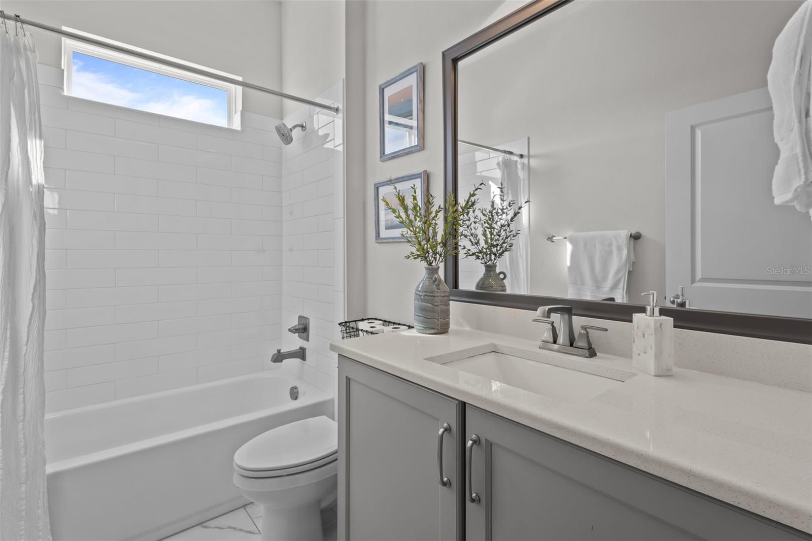 Downstairs guest full bath, quartz counters and tub/shower combo