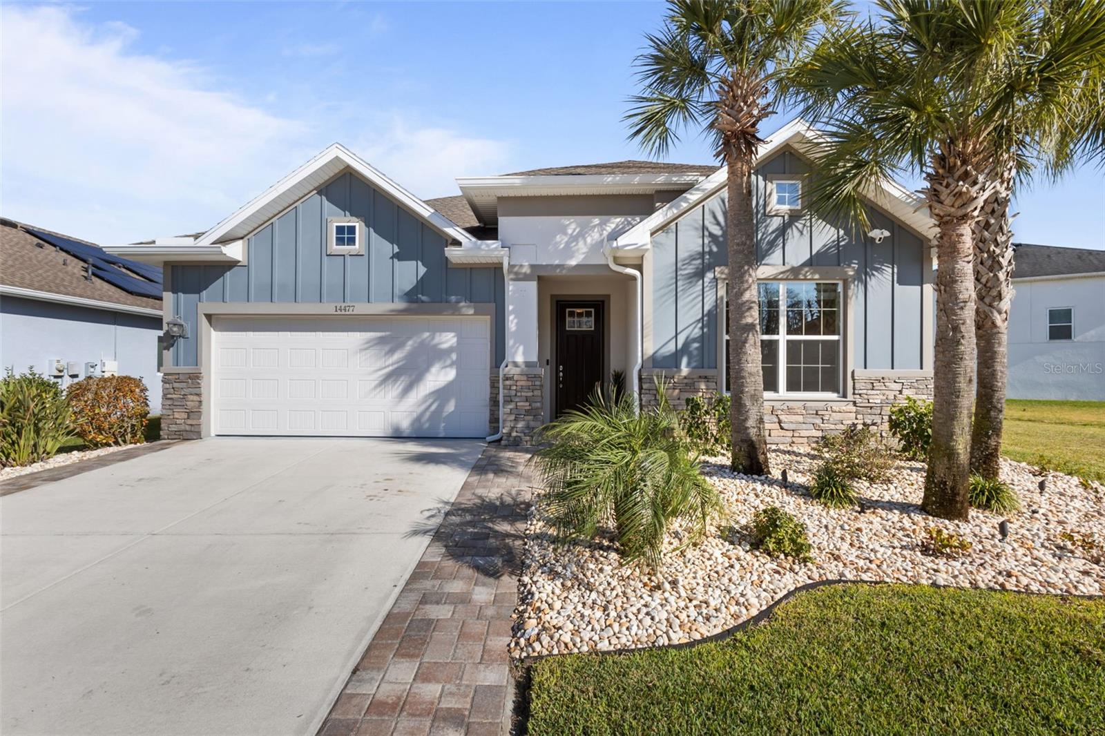 Exterior - tropical landscaping, extra pavers on driveway increasing driveway width and appearance