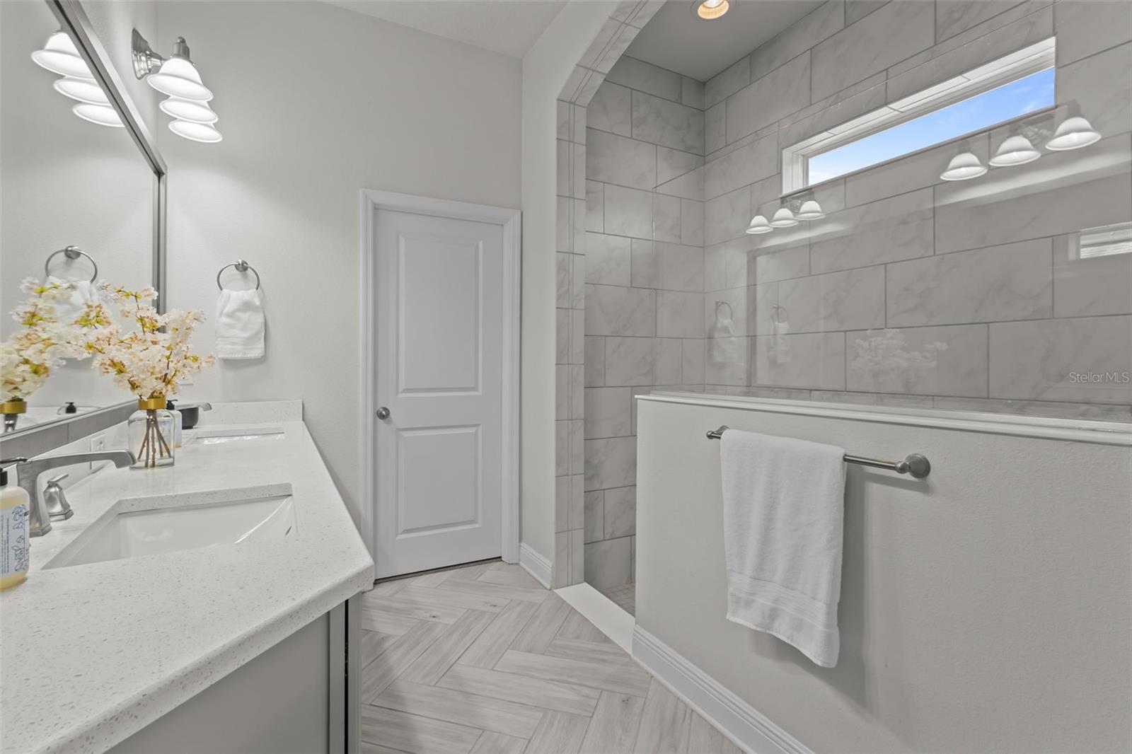 Primary en suite bathroom - double sinks, quartz counters, walk in spacious shower