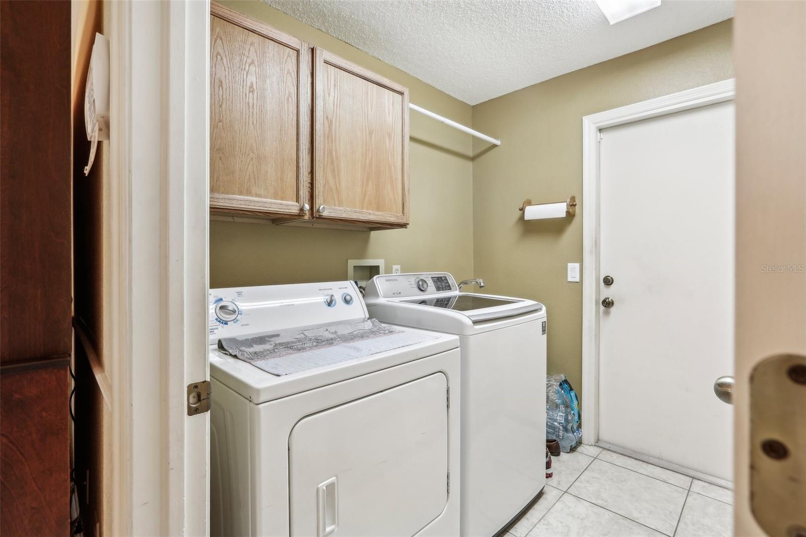 Indoor laundry room with tub sink