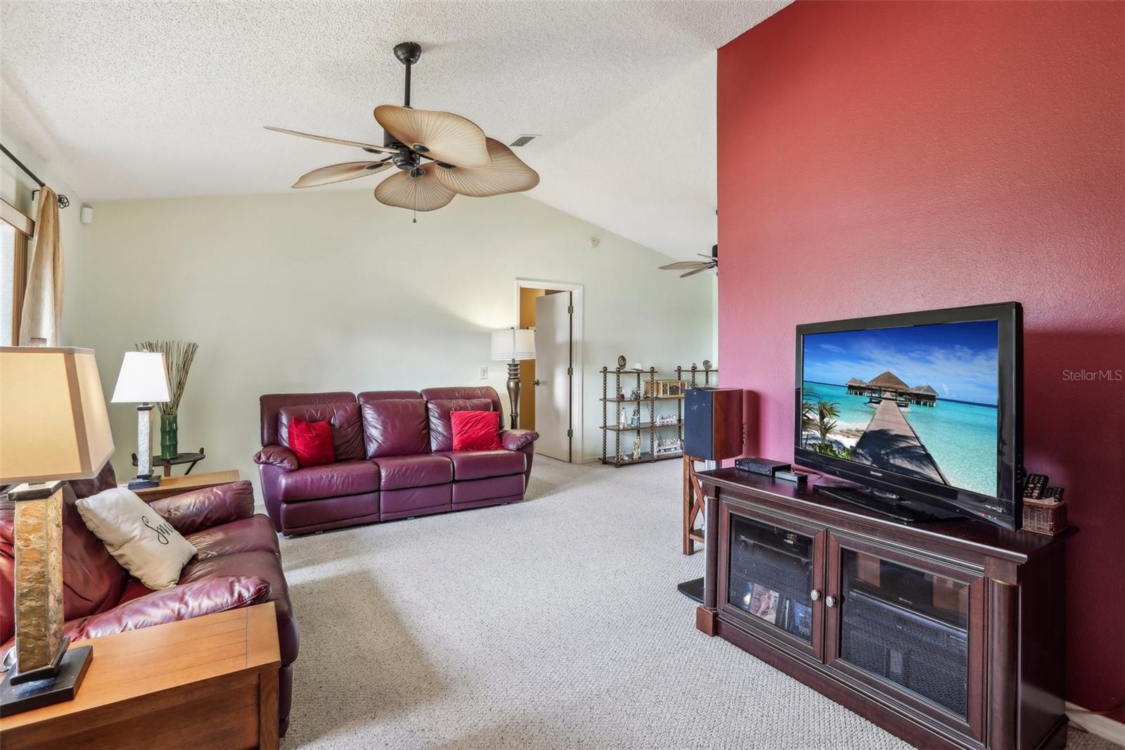 Living room looking to primary bedroom door