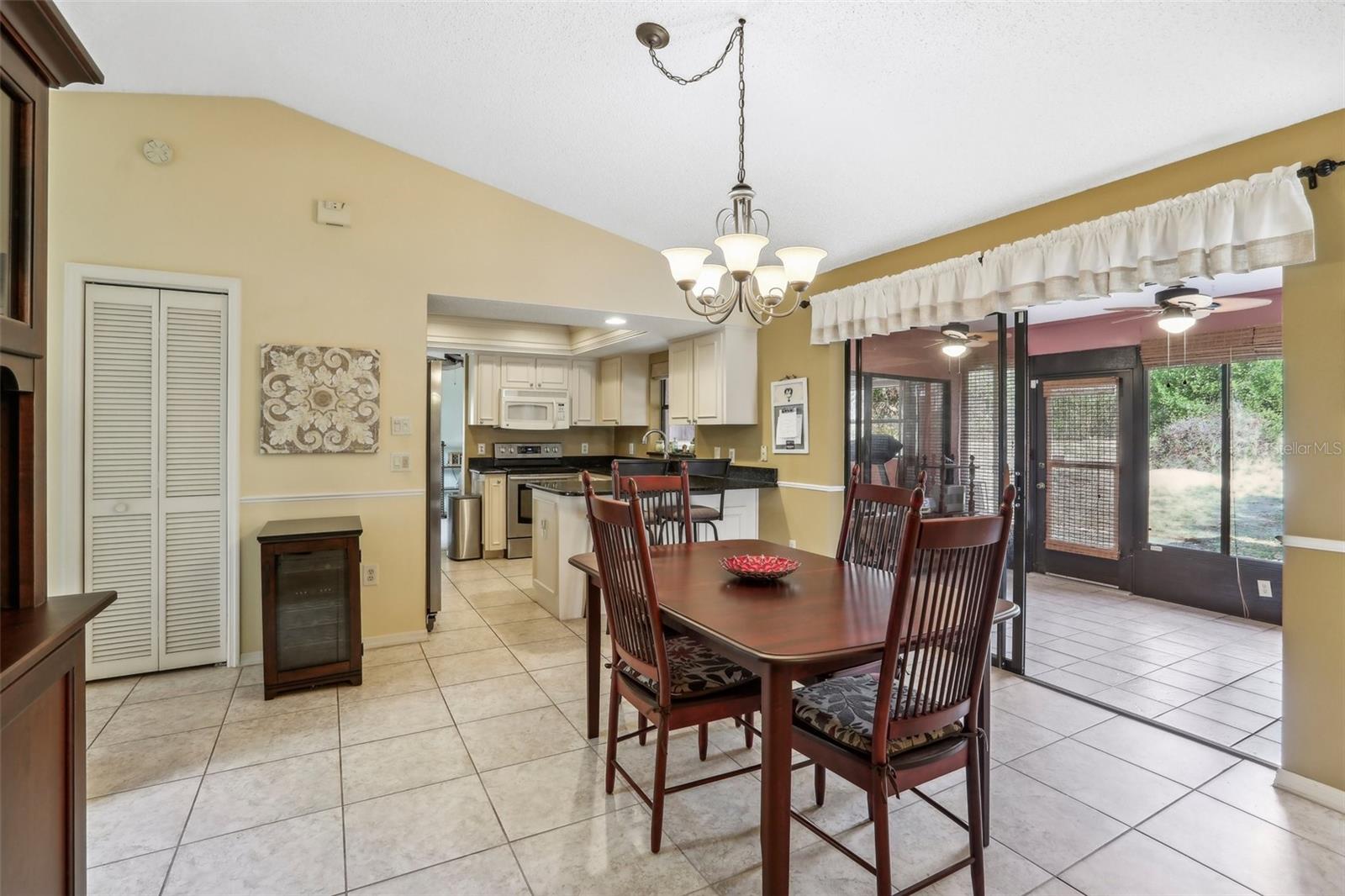 Dining room with Florida room to right and kitchen ahead