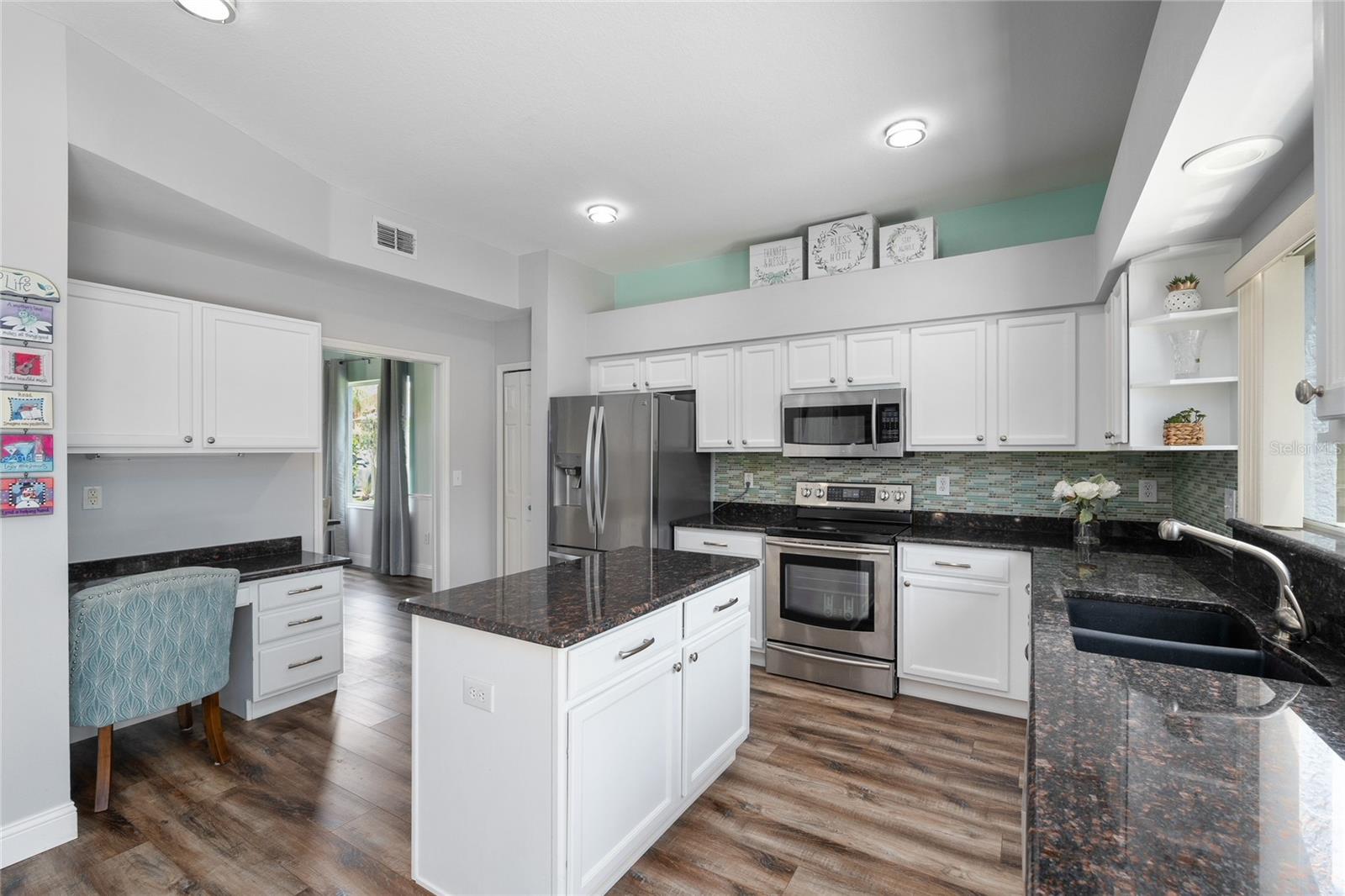 Lots of cabinet space in this large kitchen with granite countertops