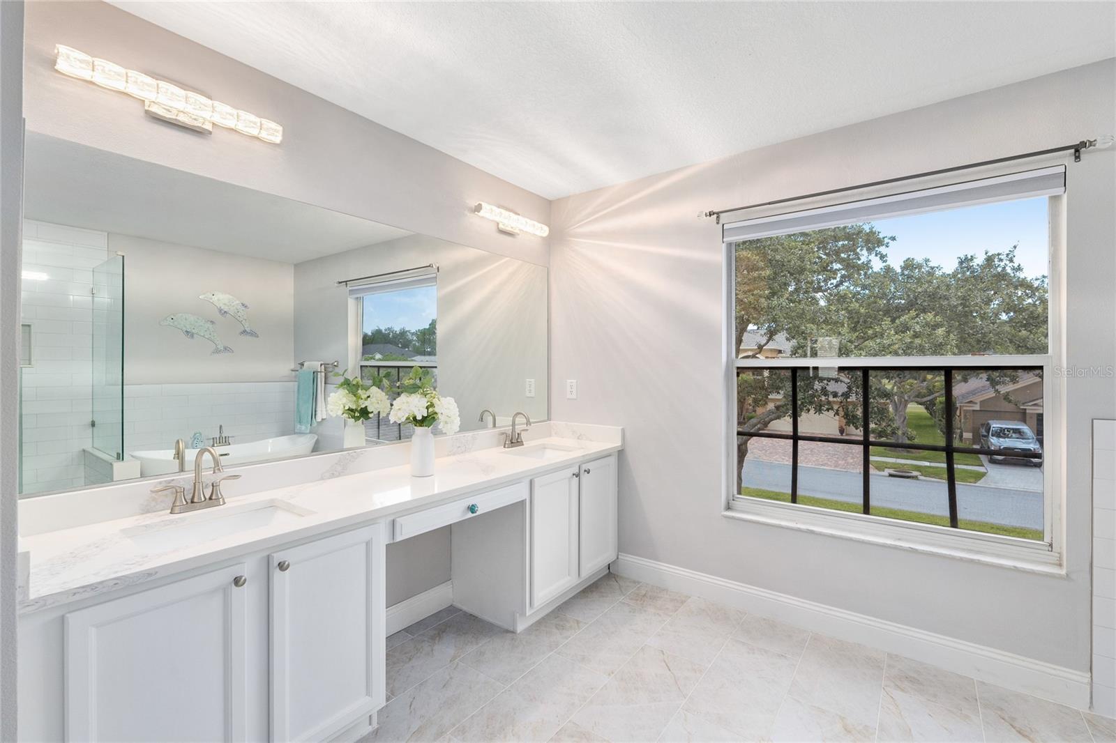 Dual sinks with granite countertops, updated lighting and fixtures