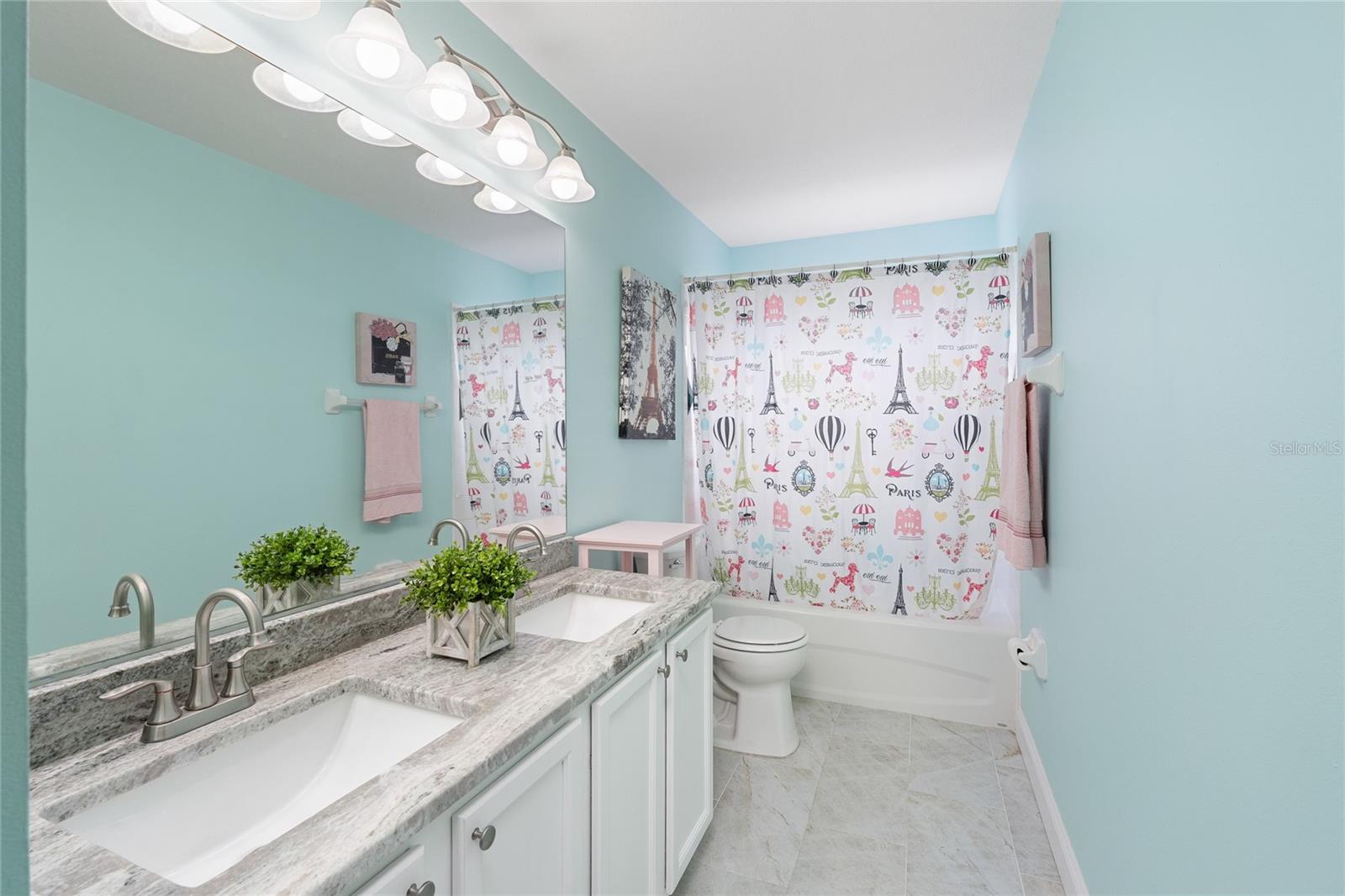 Bathroom 2 with Double granite countertops, updated lighting and fixtures