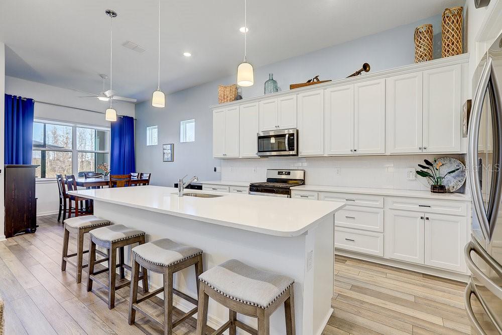 Kitchen with large island and eat in dining area. Beautiful conservation views